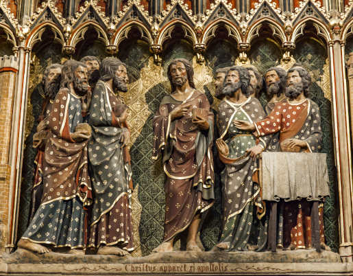 A carved wall of the Apparition to the Apostles in the Upper Room at Notre Dame Cathedral, Paris, France. The carving was made from 1300 to 1350. Photo © Boggy | Dreamstime.com