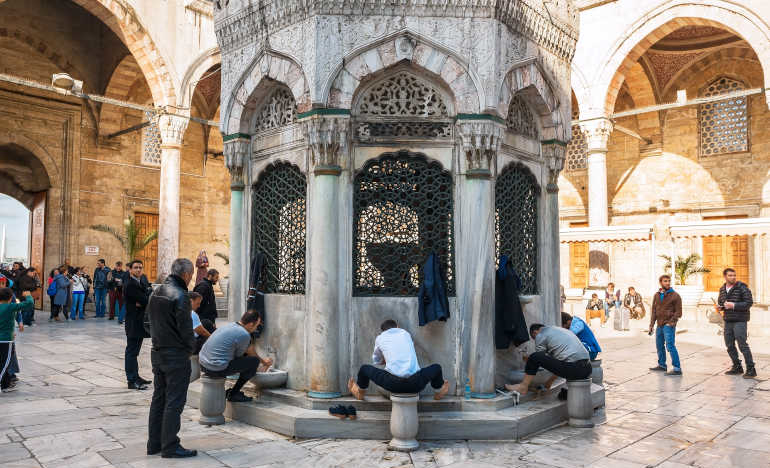 Faithful ritually wash before entering the New Mosque, or Yeni Cami, in Istanbul, Turkey. (Photo 67897545 © Naumenkoaleksandr | Dreamstime.com)